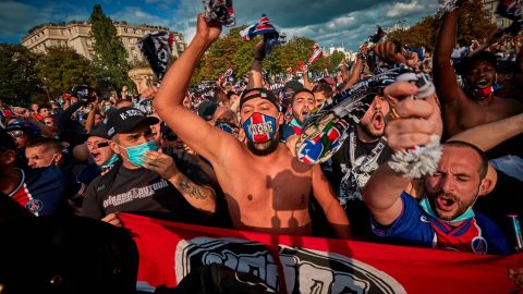 PSG fans chant near the Parc de Princes Stadium as they prepare to watch their team play.