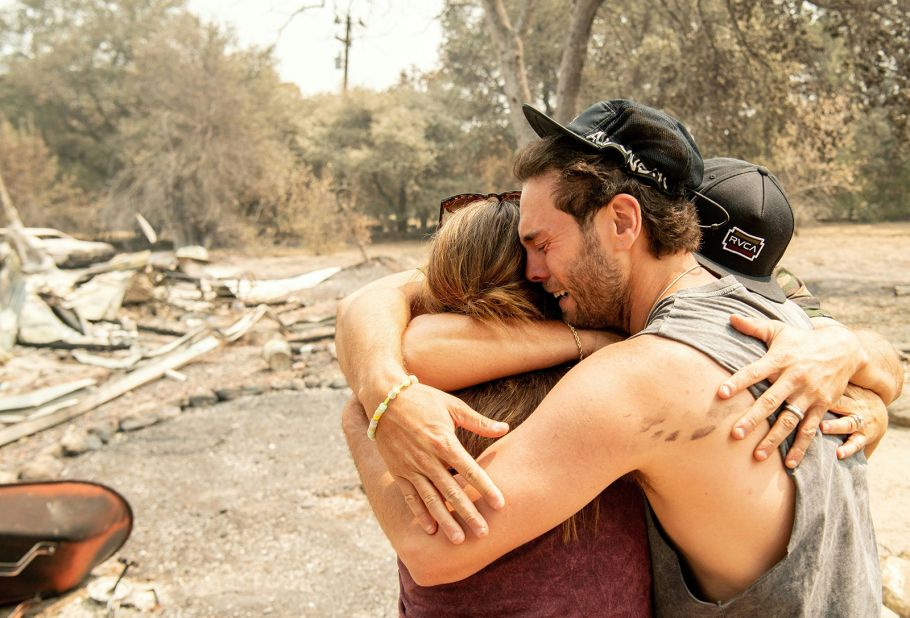 Austin Giannuzzi cries while embracing relatives at the burned remains of their Vacaville home on August 23, 2020.