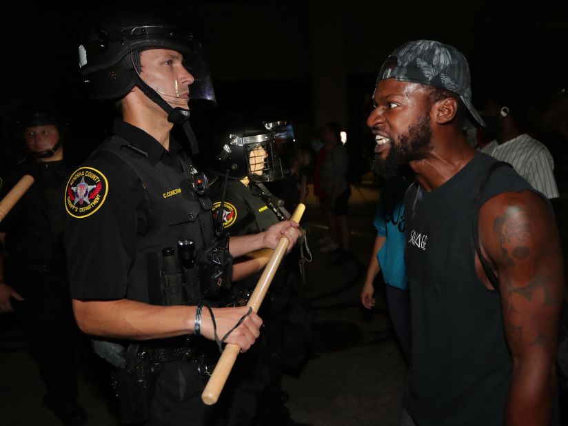 A man confronts police outside the Kenosha Police Department on August 23.