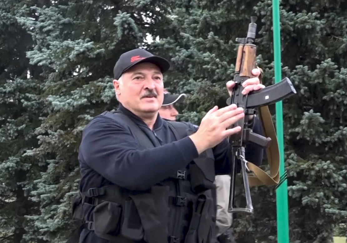 President Alexander Lukashenko brandishing a rifle near the Palace of Independence in Minsk, Sunday, as seen in video from state TV.