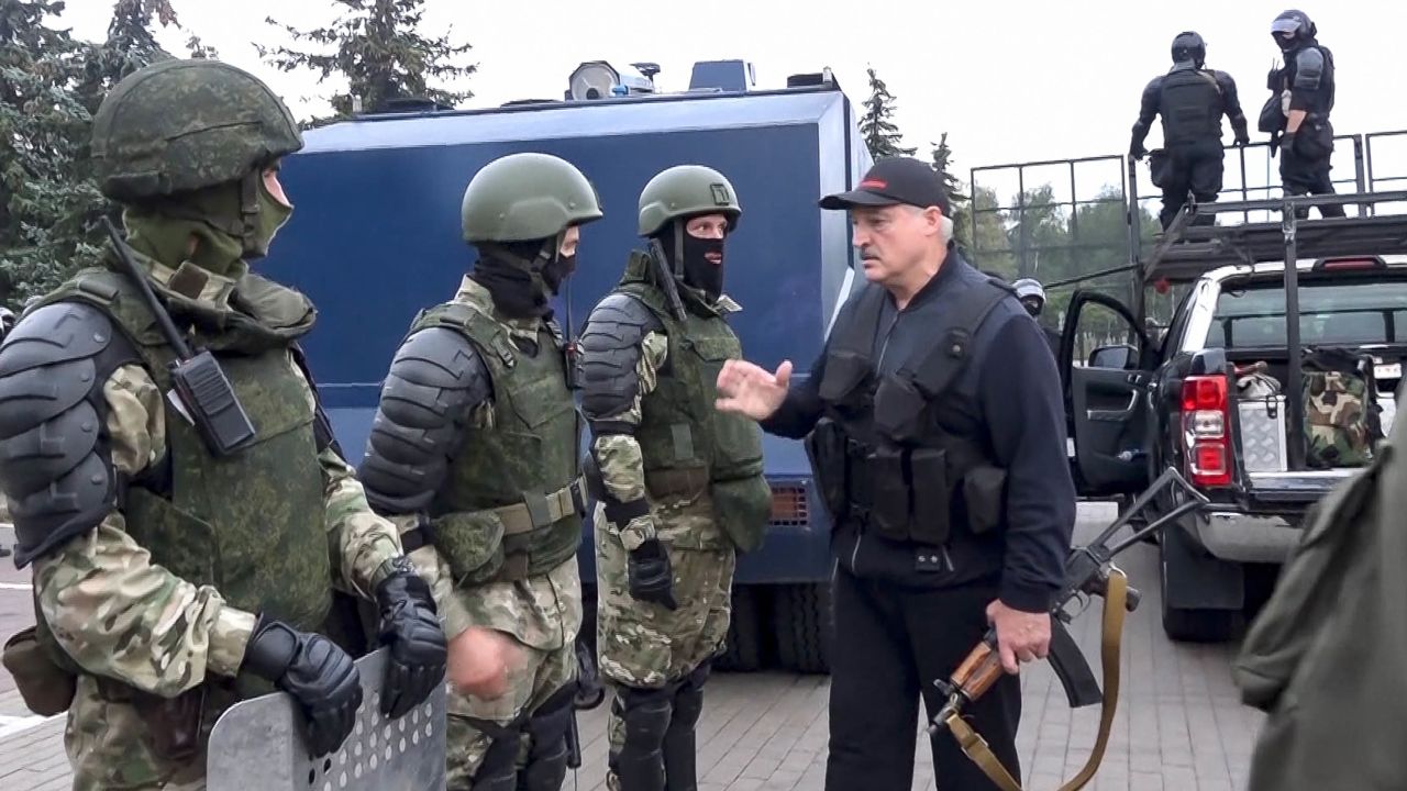 Lukashenko greets riot police near the Palace of Independence in Minsk on Sunday, in an image shown on state TV.