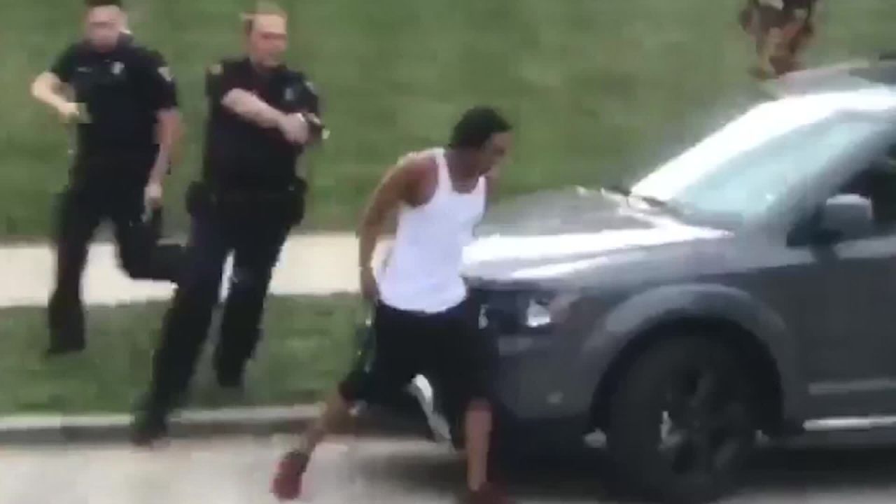 In this screengrab taken from video, police follow Jacob Blake as he walks to the driver's side door of an SUV on August 23. He was shot a few moments later.