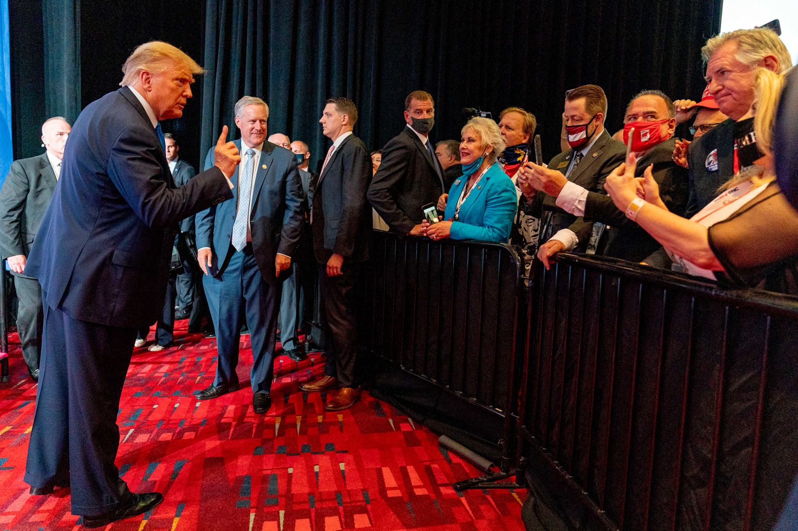 Trump poses for a photo after speaking in Charlotte early on Monday. Trump launched his convention week with <a href="index.php?page=&url=https%3A%2F%2Fwww.cnn.com%2F2020%2F08%2F24%2Fpolitics%2Ftrump-nomination-rnc%2Findex.html" target="_blank">a bitter tirade,</a> complaining that Democrats were exploiting the coronavirus pandemic to undermine his re-election. "What they're doing is using Covid to steal an election. They're using Covid to defraud the American people, all of our people, of a fair and free election," Trump said, without evidence, to applause from GOP delegates.