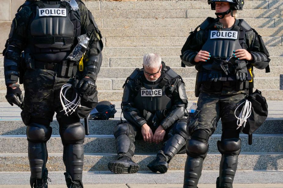Police are pictured in riot gear outside the Kenosha County Courthouse on August 24.
