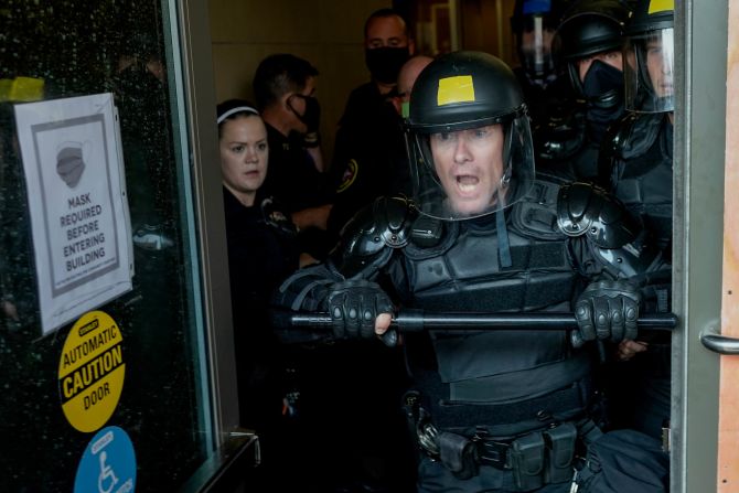 Police try to secure the Public Safety Building on August 24.