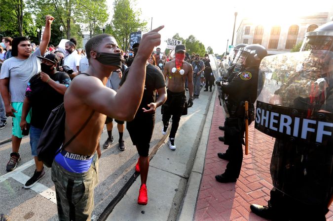 Protesters confront police officers during a march in downtown Kenosha.