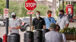 Pedestrians with face masks walk past diners in downtown Omaha, Neb., Friday, Aug. 7, 2020. (AP Photo/Nati Harnik)