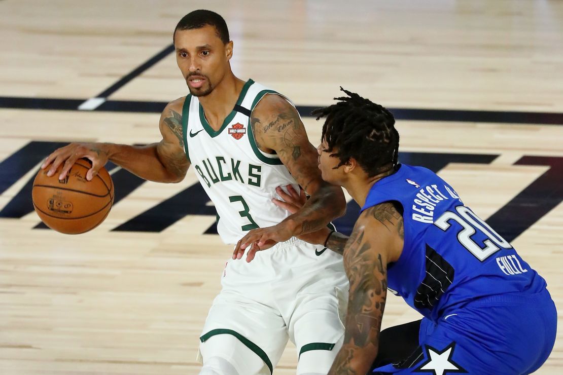 Bucks' George Hill (left) dribbles against the Orlando Magic in the NBA playoffs.