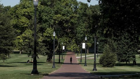 COLUMBUS, OH - AUGUST 13: A lone person makes their way through the 'Oval' at Ohio State University, a part of campus which, during the school year, is popular with students and faculty of the university, on August 13, 2020 in Columbus, Ohio. Incoming students living in the campus dormitories began moving in on the OSU campus on Wednesday. All students moving into the dormitories are required to schedule a time to move in gradually with only 8 students permitted to move into a building in the same hour as an attempt to prevent spread of the coronavirus (COVID-19) among OSU students. (Photo by Matthew Hatcher/Getty Images)
