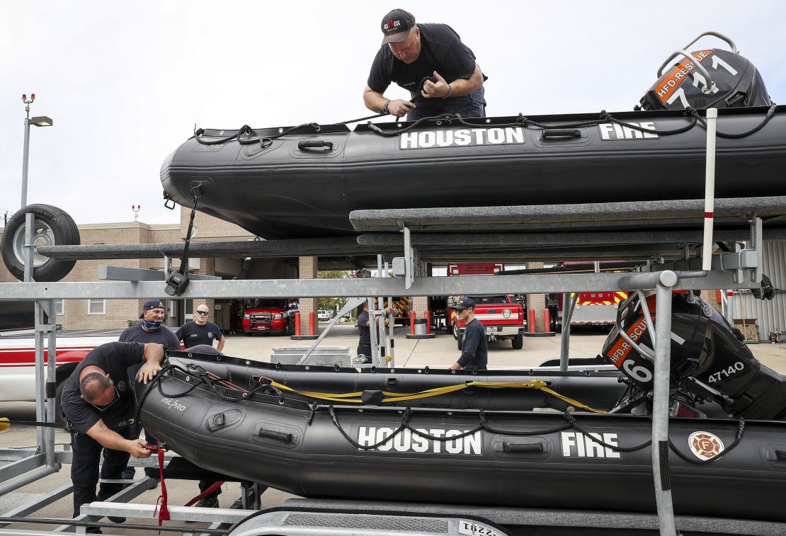 Tropical Weather
Engineer Operator Karl Carmack, left, firefighter Paul Kessler, top, and other Houston firefighters prepare water-rescue equipment Monday.