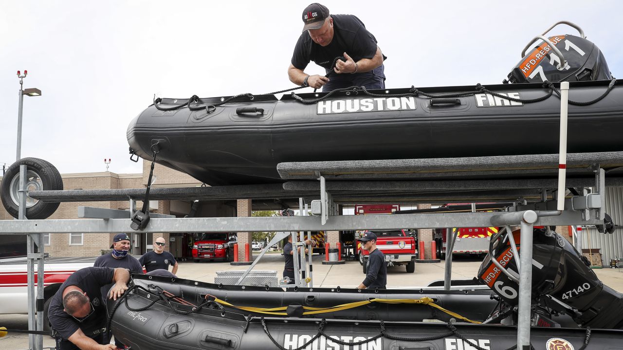 Tropical Weather
Engineer Operator Karl Carmack, left, firefighter Paul Kessler, top, and other Houston firefighters prepare water-rescue equipment Monday.