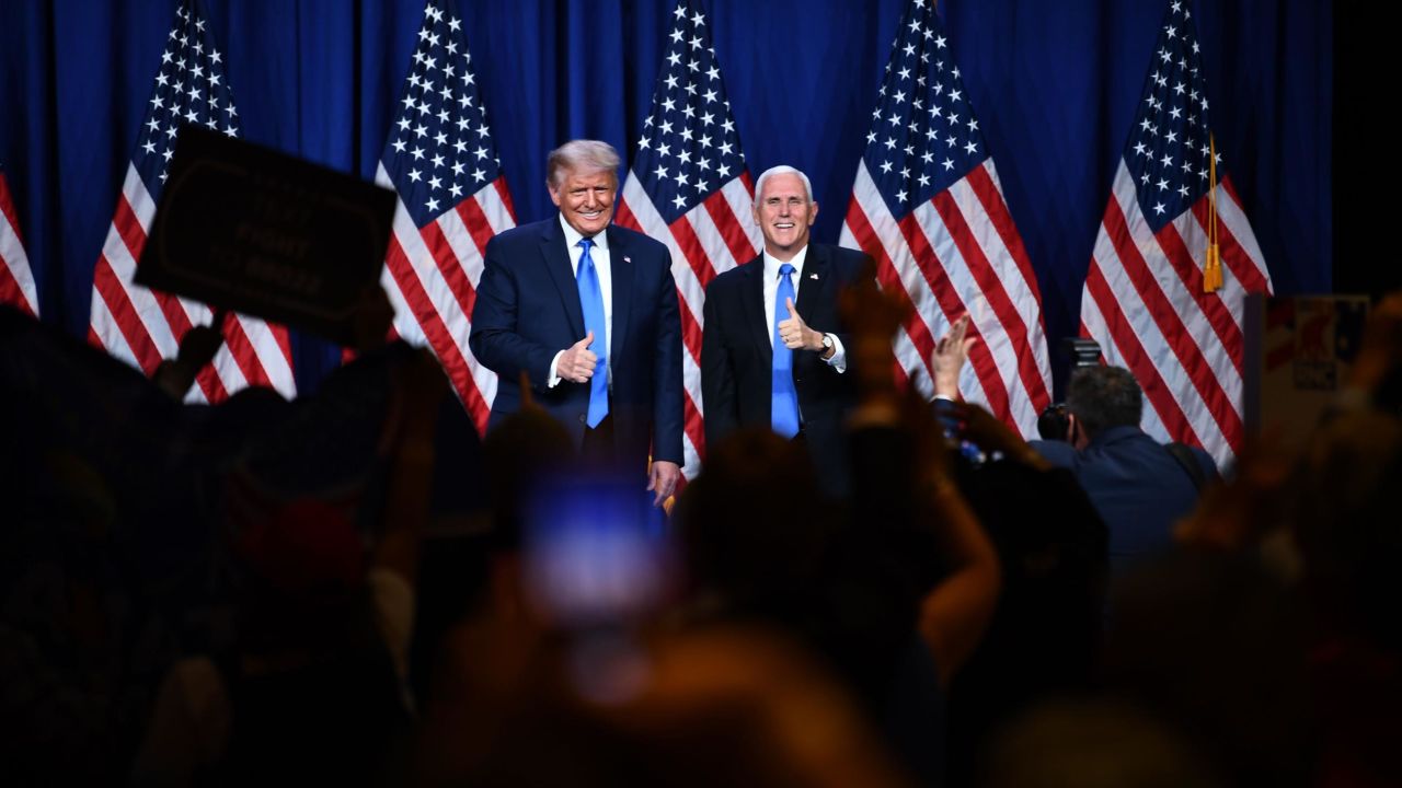 Delegates cheer as US President Donald Trump (L) and Vice President Mike Pence stand on stage during the first day of the Republican National Convention on August 24, 2020, in Charlotte, North Carolina.