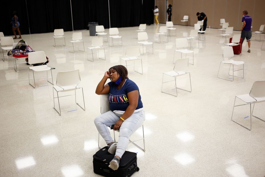 An evacuee waits to board a bus in Port Arthur, Texas, on August 25.