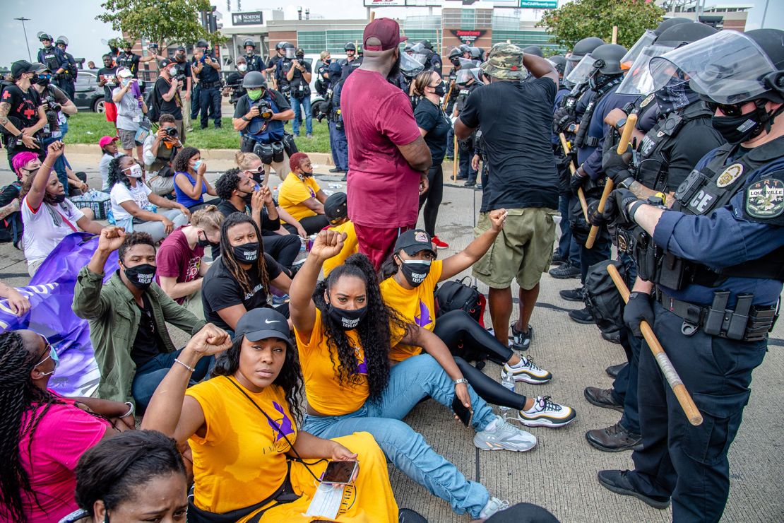 A group of demonstrators sat down in front of police during a march for Breonna Taylor in Louisville, Kentucky.