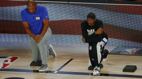 Rivers kneels with Lou Williams  during the National Anthem before the start of a game against the Dallas Mavericks.