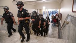 Police officers leave after Idaho State Police arrested Ammon Bundy, who refused to leave the Lincoln Auditorium in the Idaho State Capitol, Tuesday, Aug. 25, 2020, in Boise, Idaho. 