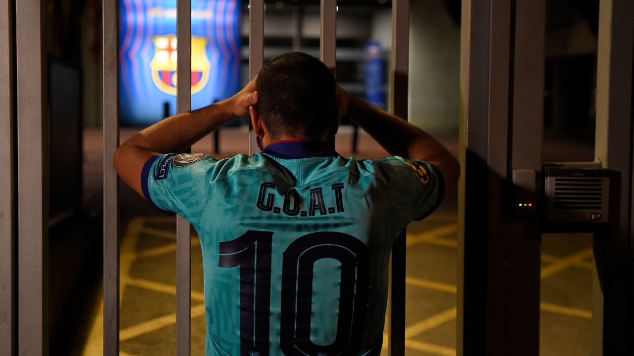 One Barcelona fan with the Greatest Of All Time on his shirt looks dejected outside the Camp Nou.