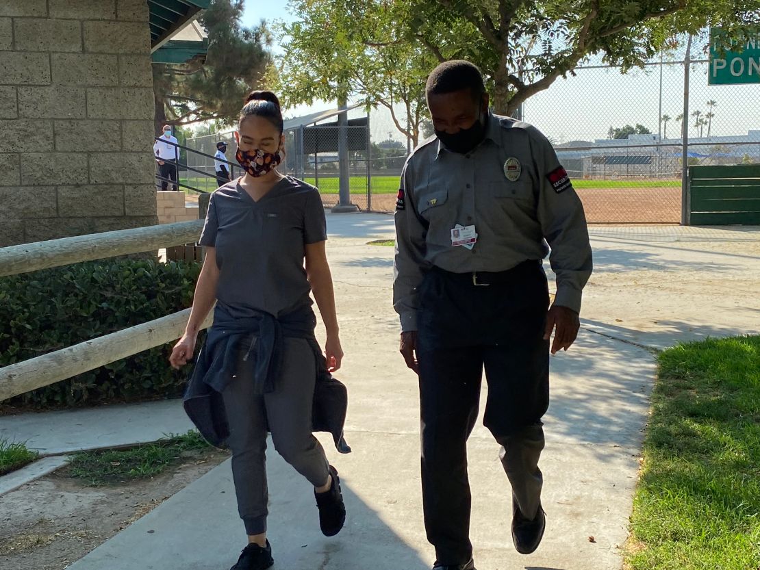 Registered nurse Kelly Wilson walks with security officer and former Marine Robert Johnson. 