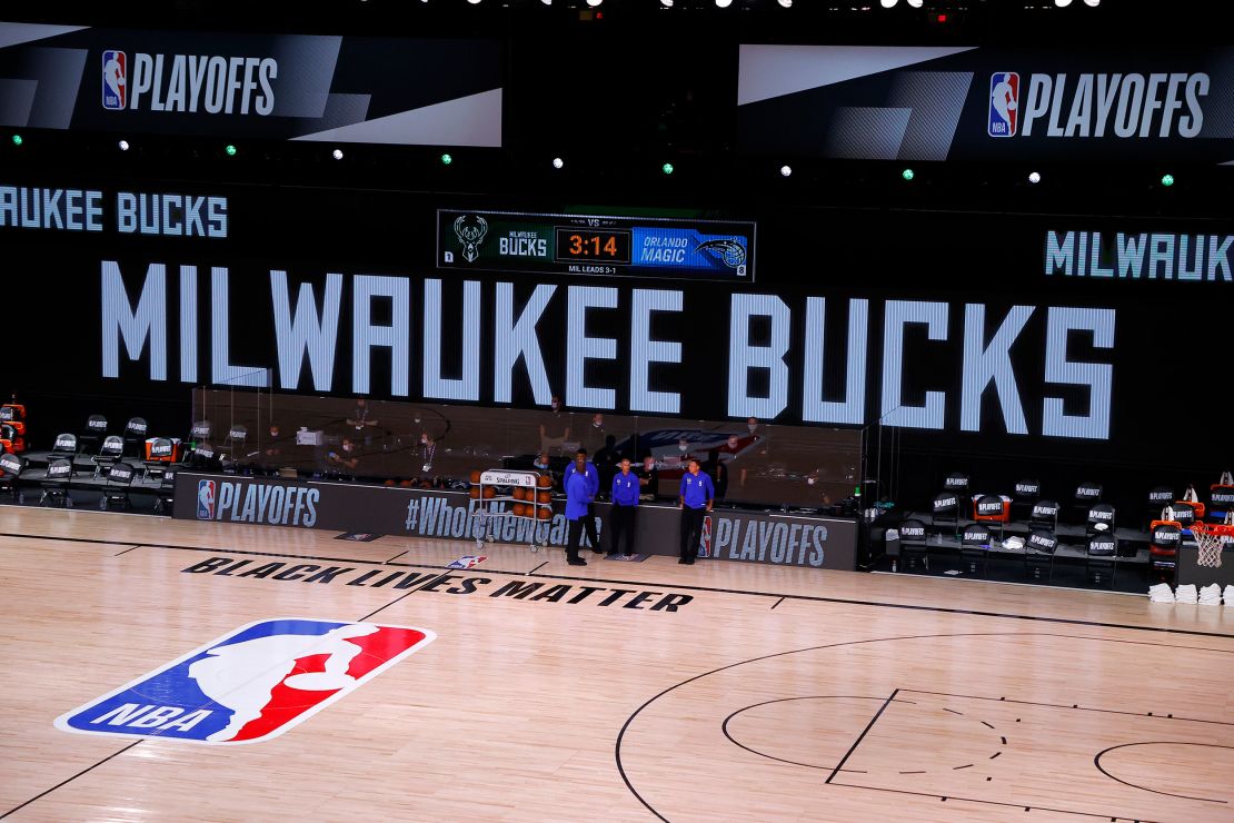 Referees stand on an empty court before the start of a scheduled game between the Milwaukee Bucks and the Orlando Magic for Game Five of the Eastern Conference First Round during the 2020 NBA Playoffs  August 26 in Lake Buena Vista, Florida.