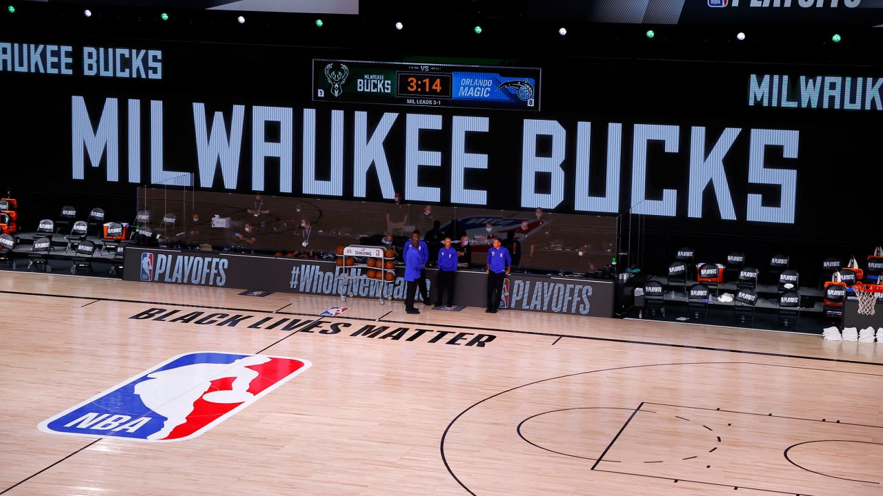 Referees stand on an empty court before the start of a scheduled game between the Milwaukee Bucks and the Orlando Magic for Game Five of the Eastern Conference First Round during the 2020 NBA Playoffs  August 26 in Lake Buena Vista, Florida.