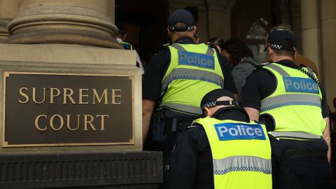 Victorian Police enter the Supreme Court of Victoria in Melbourne.