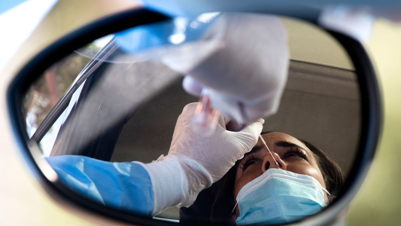 A woman undergoes a swab test for coronavirus at a drive-through testing site of the Santa Maria della Pieta hospital in Rome on August 18, 2020. - On August 16, Italy suspended its discos and ordered the mandatory wearing of masks from 6:00pm (1600 GMT) to 6:00am to clamp down on the spread of infection among young people, less than a month before the restart of school. (Photo by Tiziana FABI / AFP) (Photo by TIZIANA FABI/AFP via Getty Images)