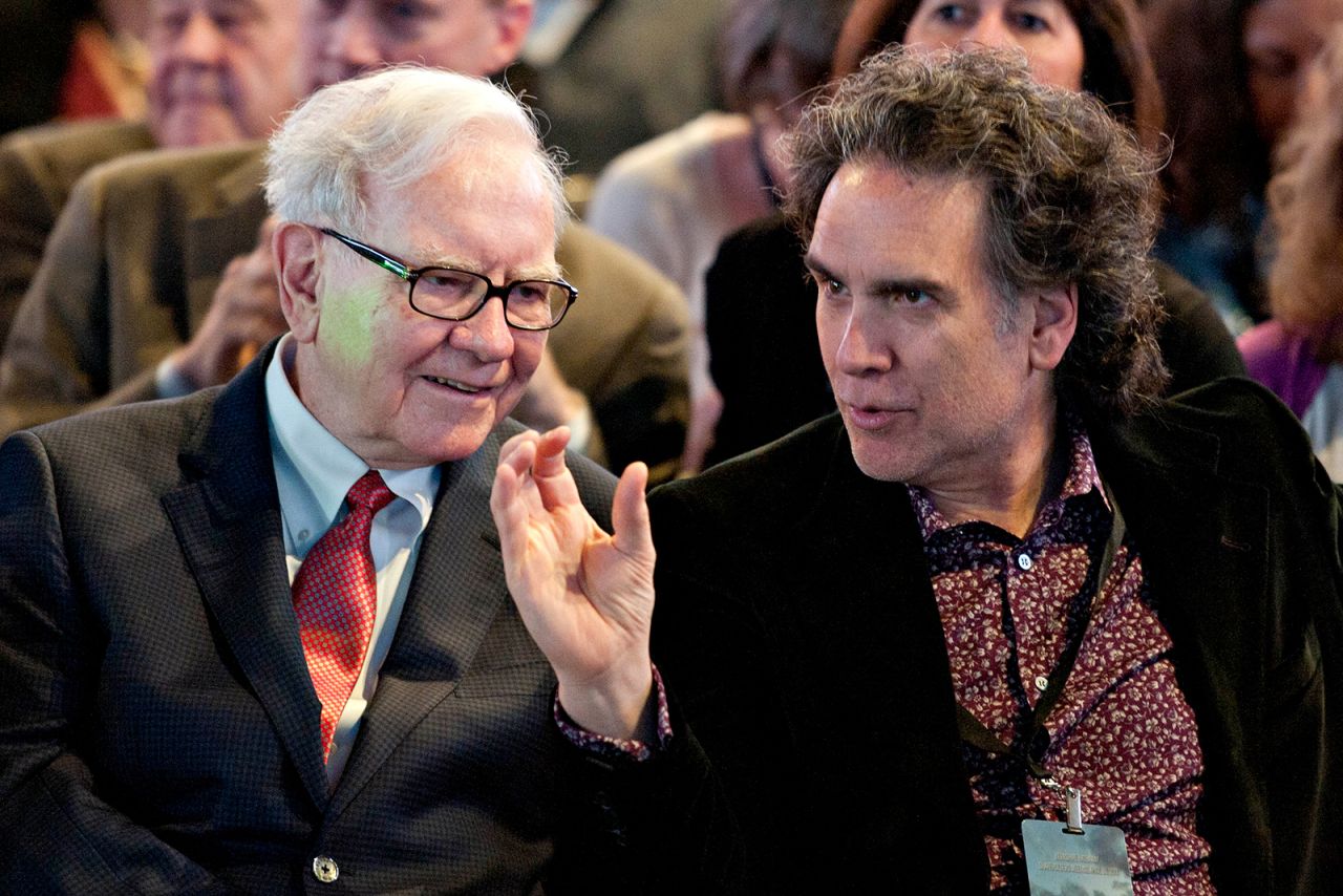 Buffett talks with his son Peter before the start of the shareholders meeting in 2011.