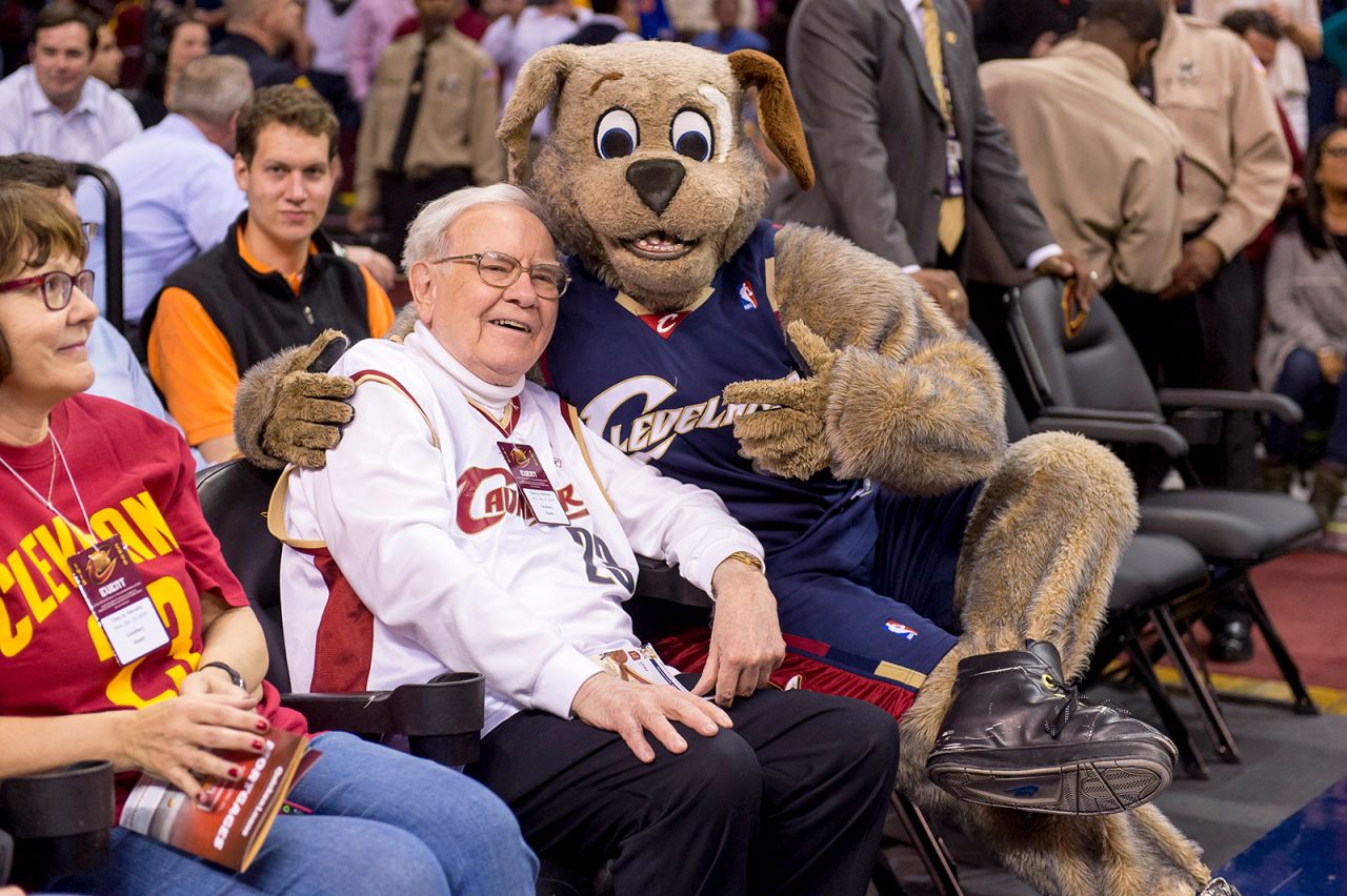 Buffett goofs off with Cleveland Cavaliers mascot Moon Dog prior to an NBA game in 2014.