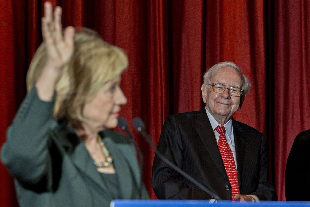 Buffett listens as presidential candidate Hillary Clinton speaks during an event in Omaha in 2015. Buffett said at the rally that he was supporting Clinton's bid for president because they share a commitment to help the less affluent.