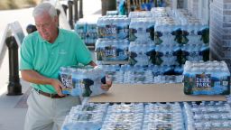 Larry Pierson, from the Isle of Palms, S.C., purchases bottled water from the Harris Teeter grocery store on the Isle of Palms in preparation for Hurricane Florence at the Isle of Palms S.C., Monday, Sept. 10, 2018. (AP Photo/Mic Smith)