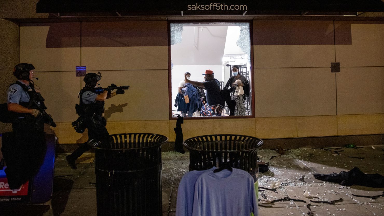 Police clear out and secure a Saks OFF 5th store in Minneapolis on August 26.