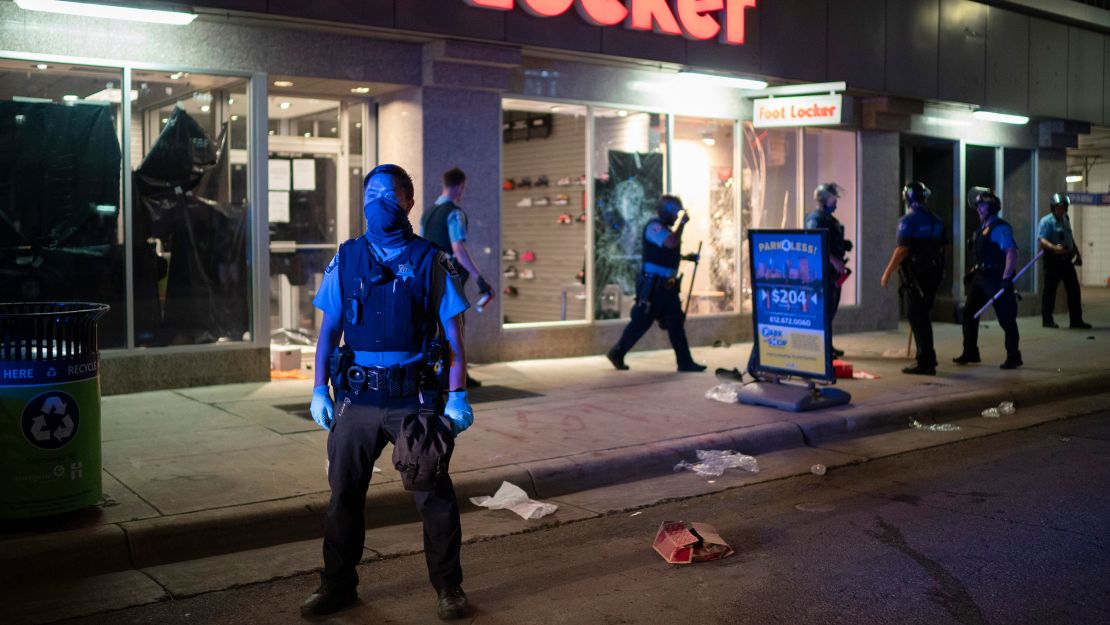 Minneapolis Police stand outside a looted Foot Locker store on Wednesday, August 26.