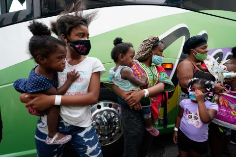 Families line up to board buses to evacuate Lake Charles on August 26.