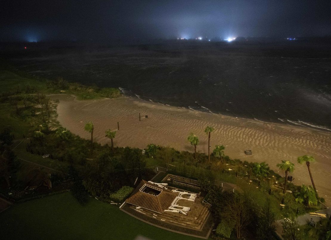 The remnants of a flattened building lie near a beach as the eye wall of Laura passes over Lake Charles, Louisiana.