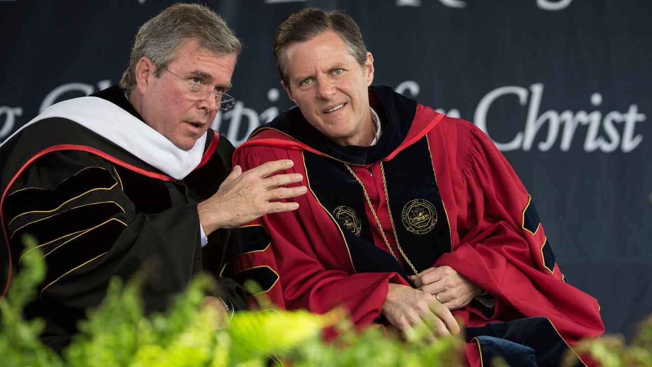 Former Florida governor Jeb Bush, then running for president, speaks with Falwell Jr. at Liberty's 2015 commencement. The school has been a frequent speaking stop for many conservative politicians.