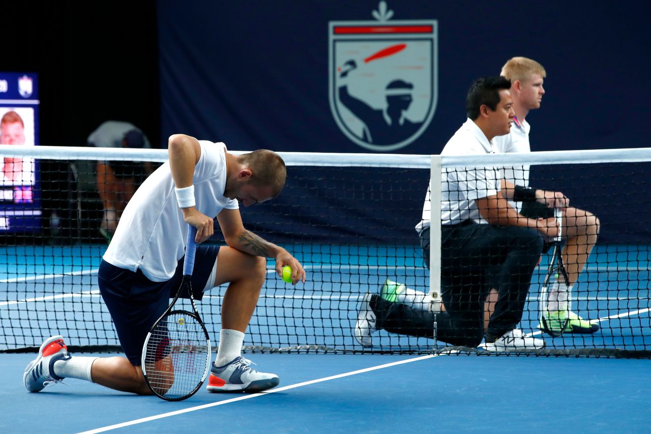 Tennis players Dan Evans and Kyle Edmund join match umpire James Keothavong in taking a knee in London on June 28.