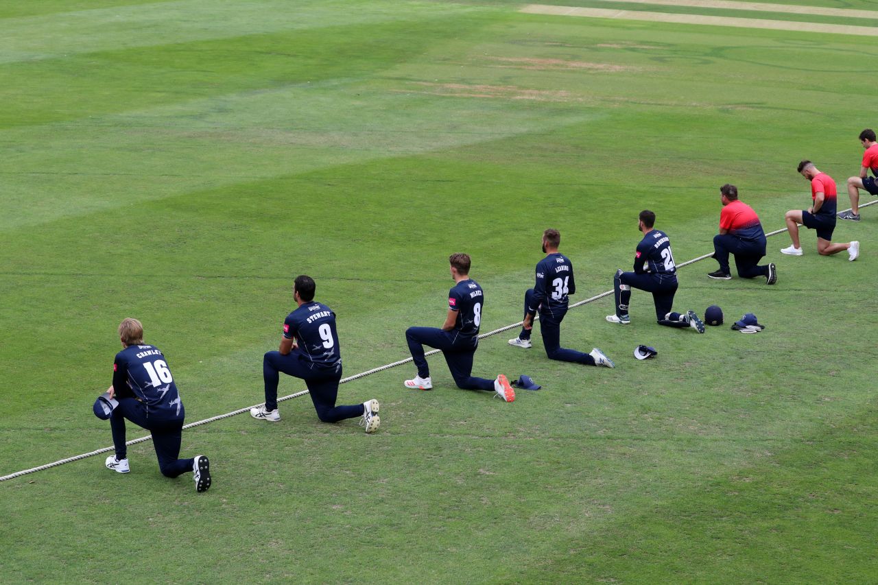 Cricketers with the Kent Spitfires take a knee during a match in Canterbury, England.