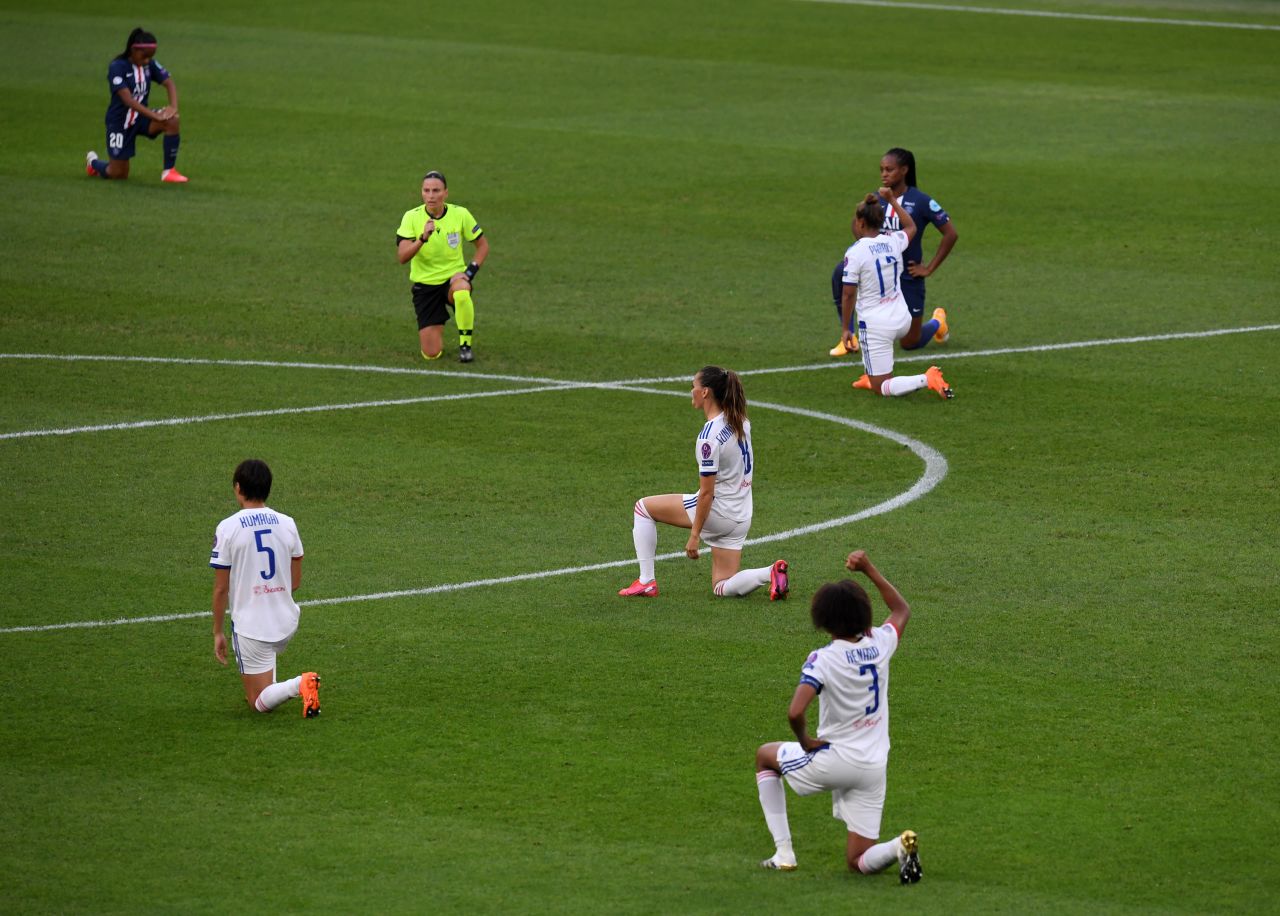 Soccer players from PSG and Lyon take a knee before a Champions League semifinal in Bilbao, Spain, on August 26.