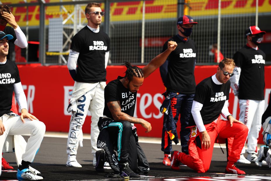 Formula One champion Lewis Hamilton raises his fist before a race in Northampton, England, on August 9.