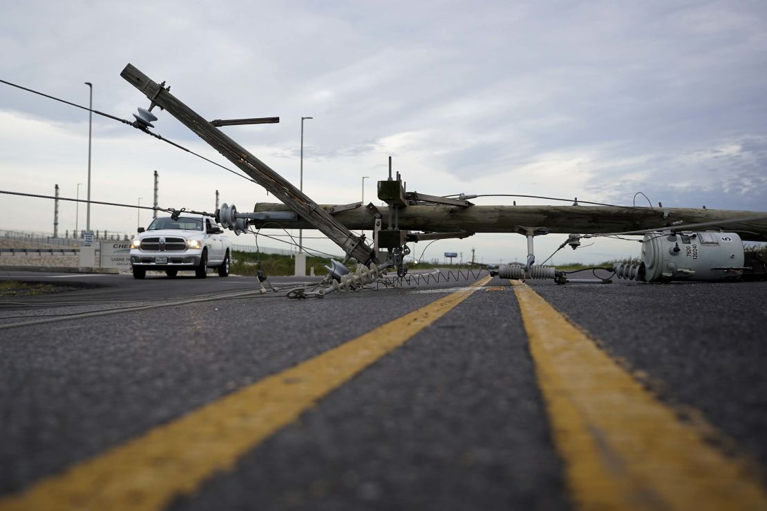 A power line downed in Hurricane Laurea stretches across a road in Sabine Pass.
