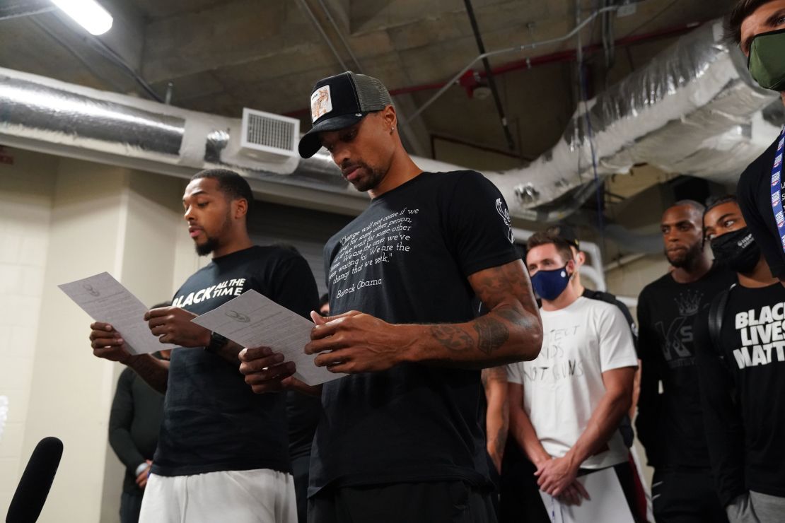 Sterling Brown and George Hill of the Milwaukee Bucks read a statement to the media on August 26.