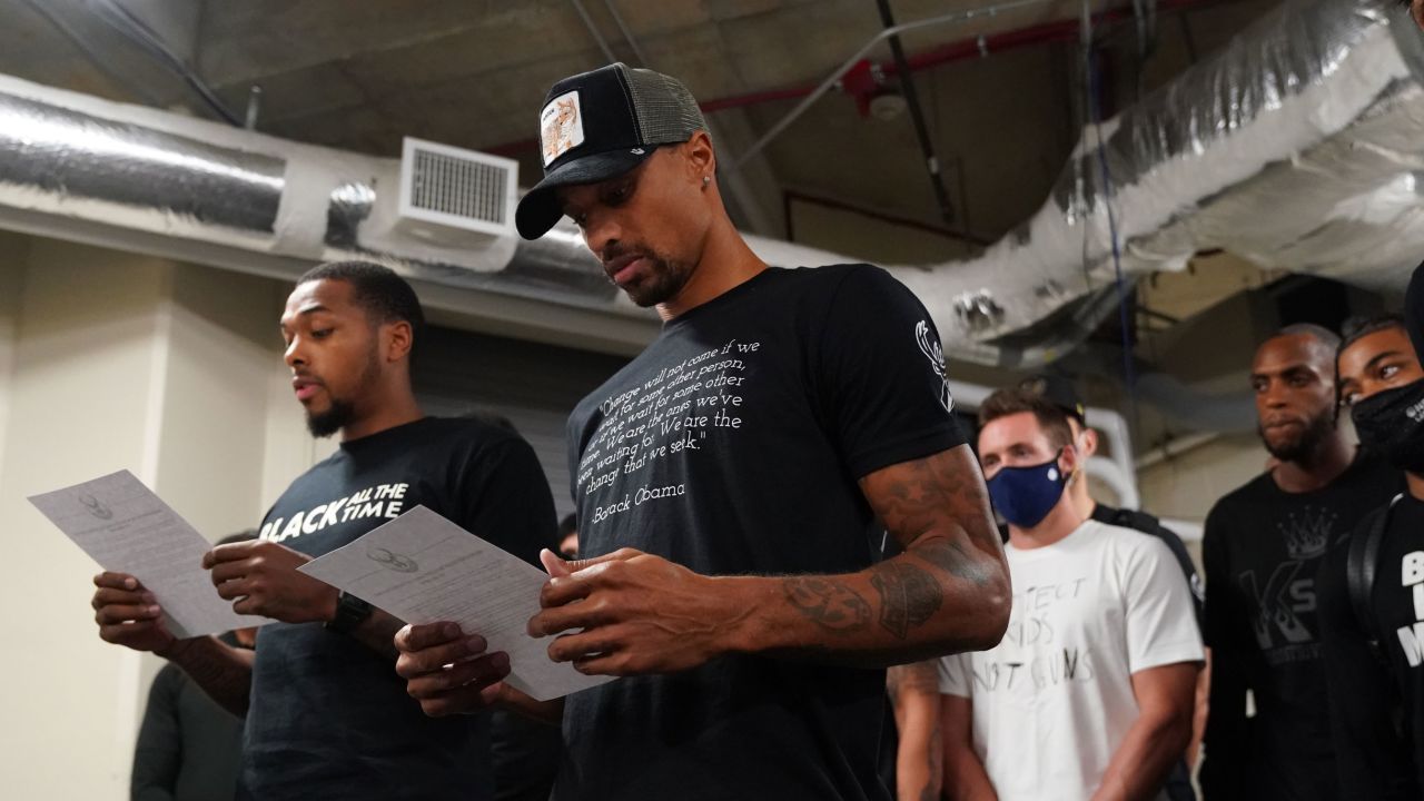 Sterling Brown and George Hill of the Milwaukee Bucks read a statement to the media on August 26.