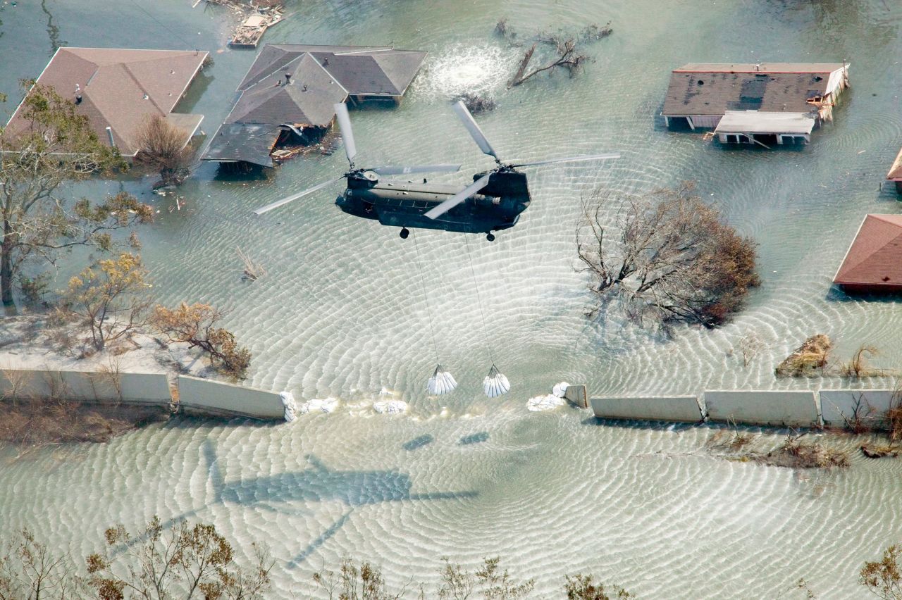 A helicopter drops sandbags to plug a levee in New Orleans on September 11, 2005.
