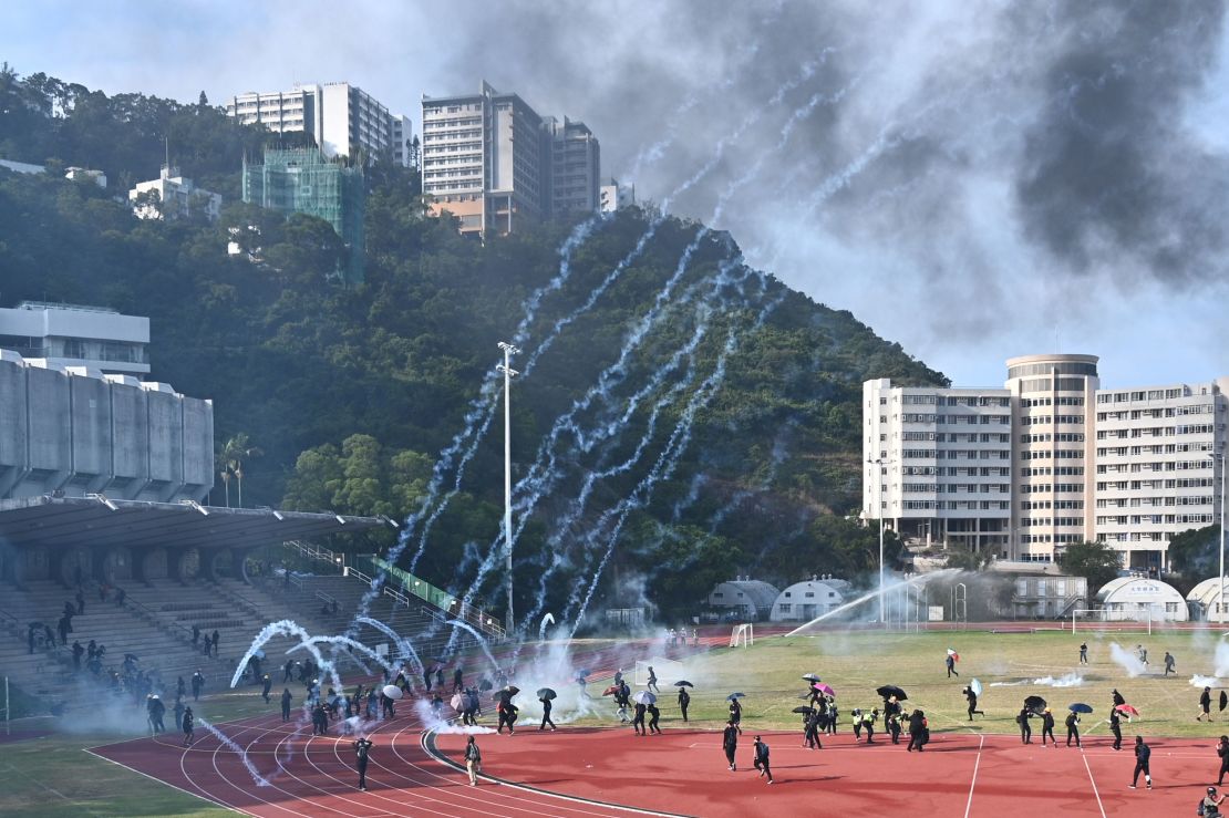 Protesters react after police fired tear gas at the Chinese University of Hong Kong (CUHK) campus on November 12, 2019.