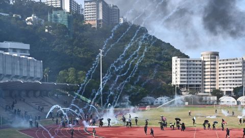 Protesters react after police fired tear gas at the Chinese University of Hong Kong (CUHK) campus on November 12, 2019.