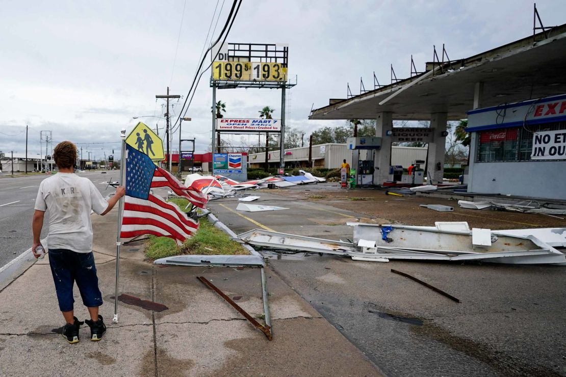 A man walks by debris at a Lake Charles gas station on Thursday.