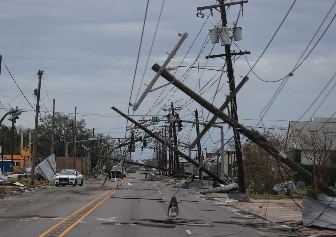 A Lake Charles street is  strewn with debris and downed power lines Thursday after Laura passed through.