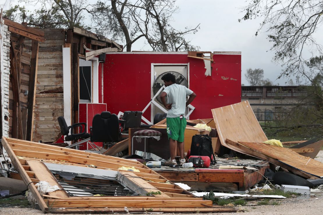 A man surveys what is left of his uncle's barber shop in Lake Charles.