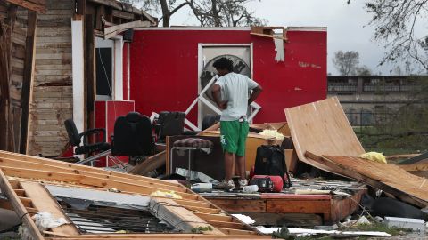A man surveys what is left of his uncle's barber shop in Lake Charles.