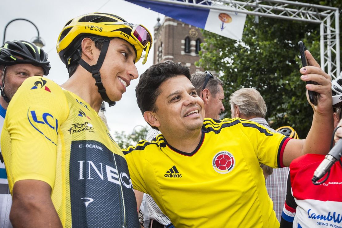 Colombia's Tour de France winner Egan Bernal (L) poses for a 'selfie' with a supporter from Colombia ahead of the start of the Acht van Chaam criterium cycling race in Chaam on July 31, 2019.